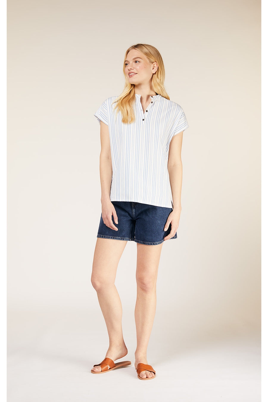 A standing model wearing a relaxed fitting striped top. 